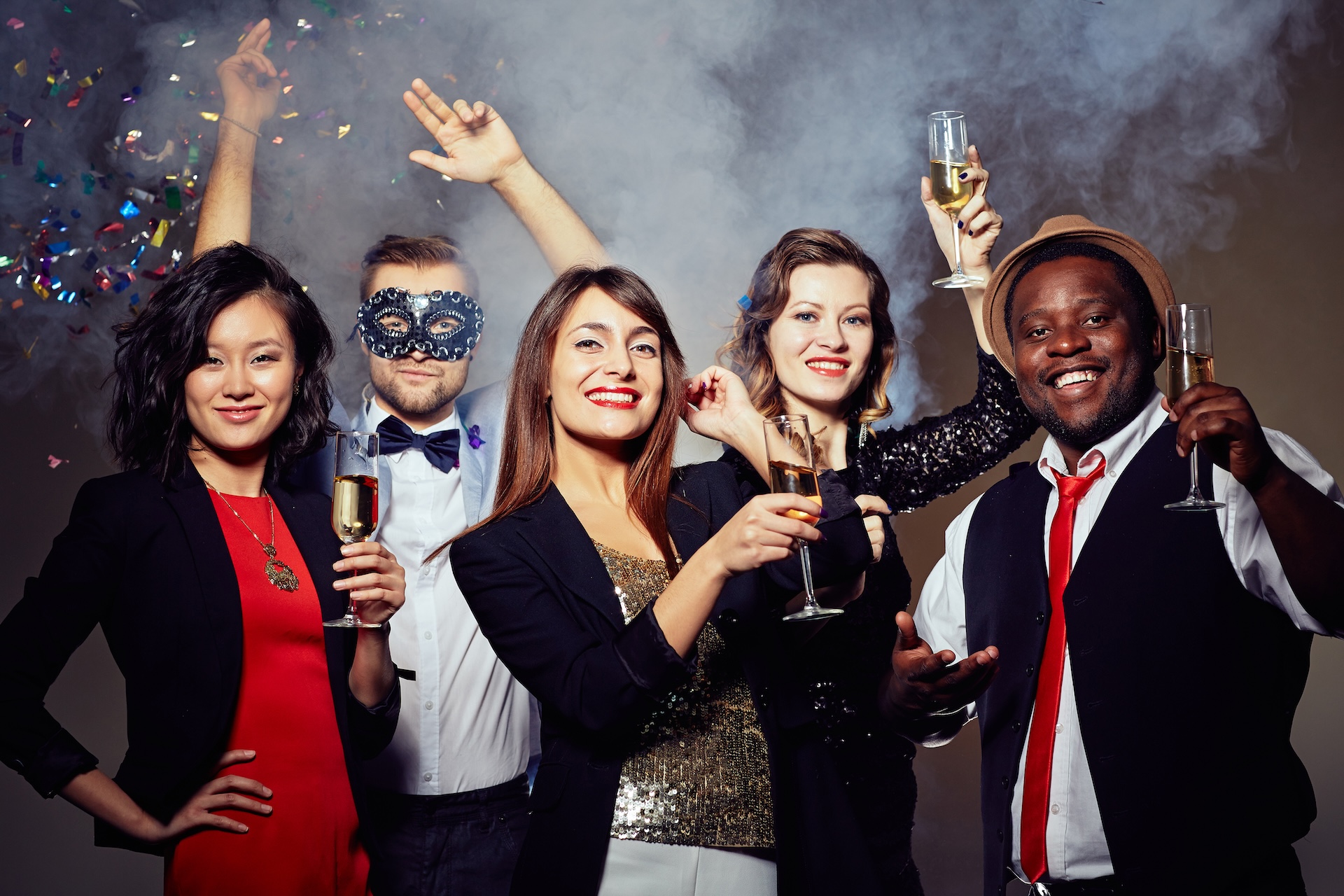 Group of happy friends with champagne enjoying party Groupe de personnes célébrant avec champagne lors d'une fête élégante.